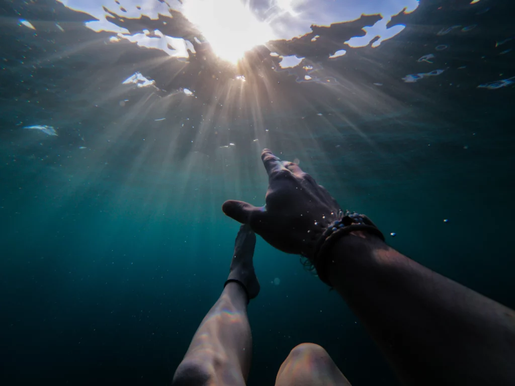 Underwater, swimming, sunlight through the surface